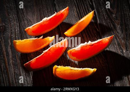 sliced grapefruit orange on wood background Stock Photo