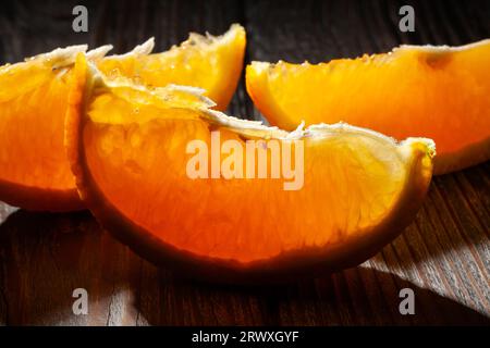 sliced orange on wood background Stock Photo