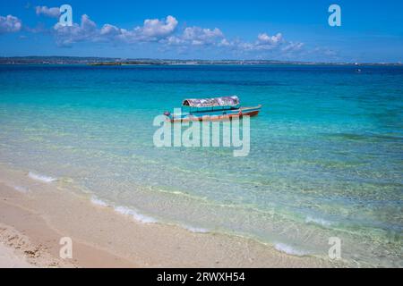 Boats floating parked by a sand bank in Zanzibar, Tanzania Stock Photo