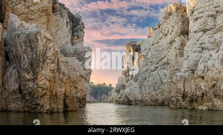 White Marble rocks alongside Narmada River during sunset in famous Bhedaghat, Jabalpur District, Madhya Pradesh, India. Stock Photo