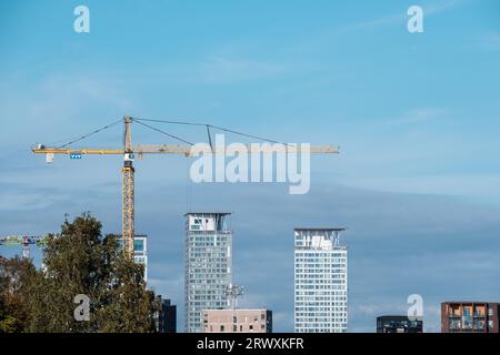 Helsinki / Finland - SEPTEMBER 18, 2023: A construction crane against a bright blue sky. Operated by Finnish multinational construction and developmen Stock Photo