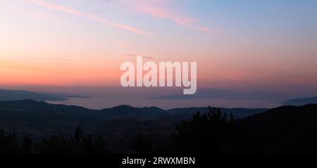 Stunning landscape panorama from Bulgarian mountains with a sea of fog and distance mountains during sunrise. Stock Photo