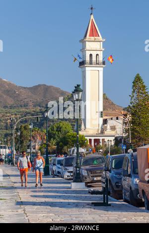 Zakynthos, Greece - August 14, 2016: People walk the coastal street  of Zante port, vertical photo Stock Photo