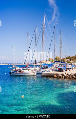 Zakynthos, Greece - August 20, 2016: Sailing yachts are moored in Agios Nikolaos. Popular touristic destination for summer vacations, vertical photo Stock Photo