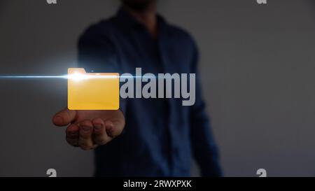 Document Management System DMS .Businessman hold folder and document icon.Software for archiving, searching and managing corporate files. Stock Photo