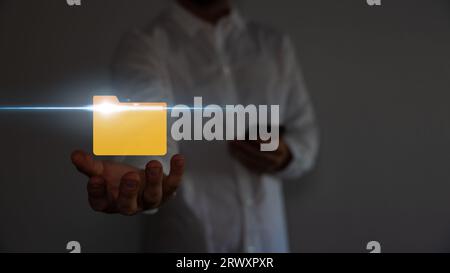Document Management System DMS .Businessman hold folder and document icon.Software for archiving, searching and managing corporate files. Stock Photo