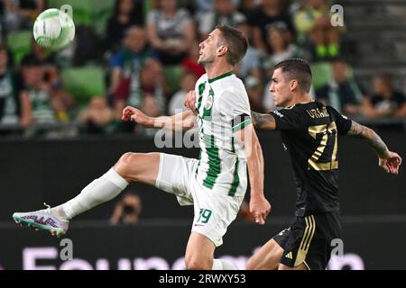 Budapest, Hungary. 31st August, 2023. Barnabas Varga of Ferencvarosi TC  competes for the ball with Nassim Hnid of FK Zalgiris Vilnius during the  UEFA Europa Conference League Play Off Round Second Leg