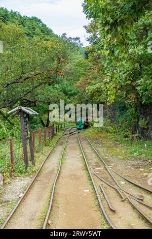 Trolley rails leading from Takato Park to the entrance of Takato Mine at Sado Kinzan Stock Photo