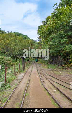 Trolley rails leading from Takato Park to the entrance of Takato Mine at Sado Kinzan Stock Photo