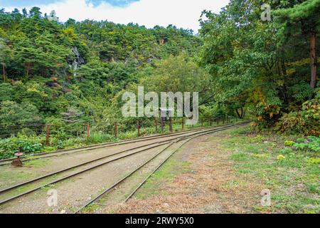 Trolley rails leading from Takato Park to the entrance of Takato Mine at Sado Kinzan Stock Photo