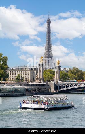 Batobus cruise boat and Eiffel Tower across River Seine, Port des Champs-Élysées, 8th arrondissement, Paris, Île-de-France, France Stock Photo