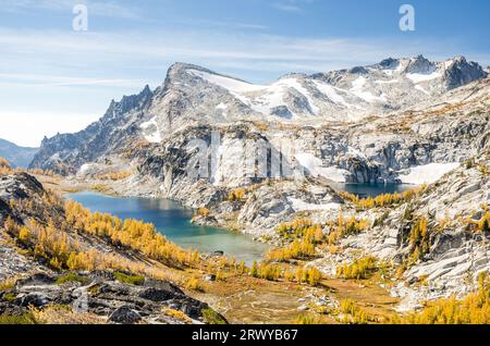 Big view from Purisk Pass of Perfection Lake, Inspiration Lake, and snow covered Little Annapura during the larch fall color in the Enchantment Lakes Stock Photo