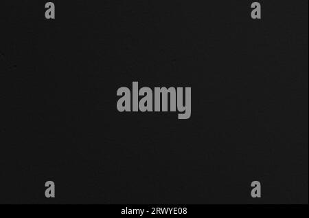 Close-up of a clean, painted and plastered dark gray, almost black, wall. Abstract high resolution full frame textured background with copy space. Stock Photo
