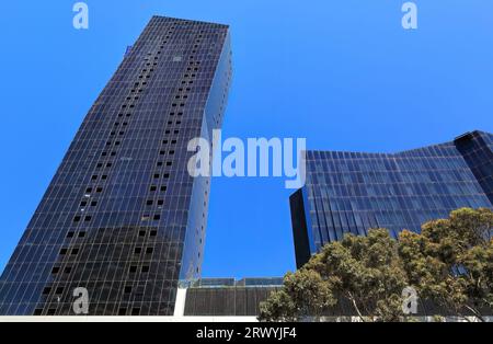 Residential development in the Docklands area featuring two conjoined, inclined, shimmering facade, 36 and 43-storey towers splitting at the 21st stor Stock Photo