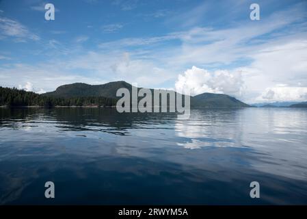 Lush rainforest is covering the calm waters of Inland Passage between the east coast of Vancouver Island and the Canadian mainland. Stock Photo