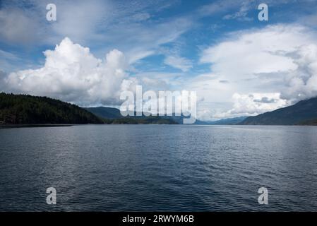 Lush rainforest is covering the calm waters of Inland Passage between the east coast of Vancouver Island and the Canadian mainland. Stock Photo