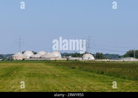 large biogas plant beside high-voltage power transmission line, Germany, Bavaria, Pliening Stock Photo