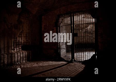 Light glowing from Iron grate in old cellar. Stock Photo