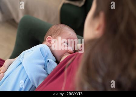 Nude mother breastfeeding infant son Stock Photo - Alamy
