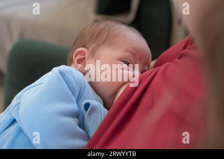 Nude mother breastfeeding infant son Stock Photo - Alamy
