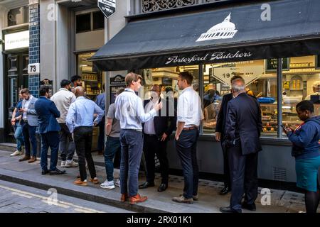 City of London Workers Queue For A Takeaway Lunch At The Porterford Butchers In The City of London, London, UK. Stock Photo