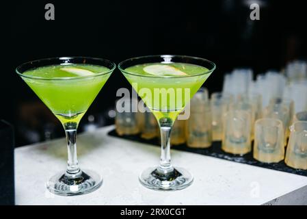 Green cocktail in a martini glass on a bar counter in a nightclub Stock Photo
