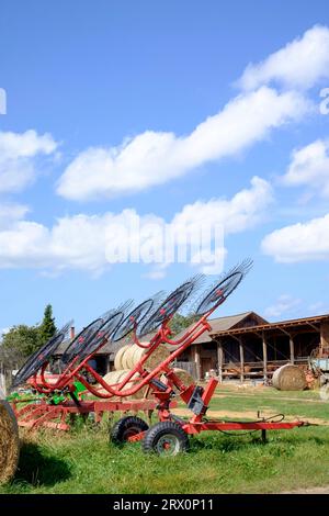 farming agricultural implement tractor towed trailer wheel rake Stock Photo
