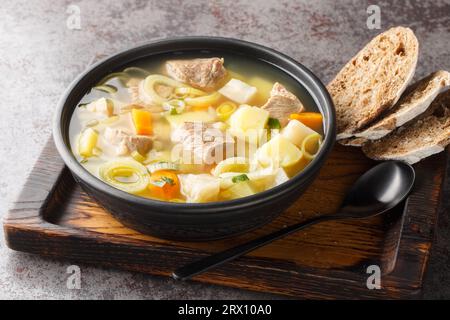 Kottsoppa soup is a meat and root vegetables include carrot, potato, celeriac, parsnip, turnip and Rutabaga close-up on a plate on the table. Horizont Stock Photo