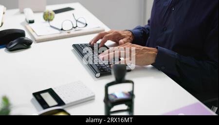 Man Working In Office On Desktop PC Stock Photo