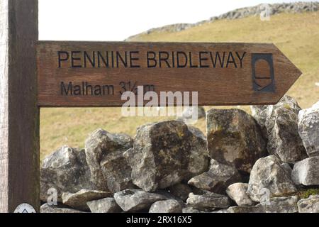 Wooden Signpost for Pennine Bridleway to Malham on Stockdale Lane near Settle in the Yorkshire Dales National Park, England, UK. Stock Photo