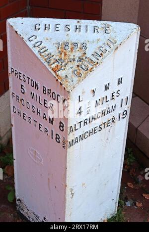 Cheshire County Council white metal mile post 1898 - to Lymm, Manchester, Altrincham, at Stockton Heath A49, A56 junction, Warrington, England, UK, Stock Photo