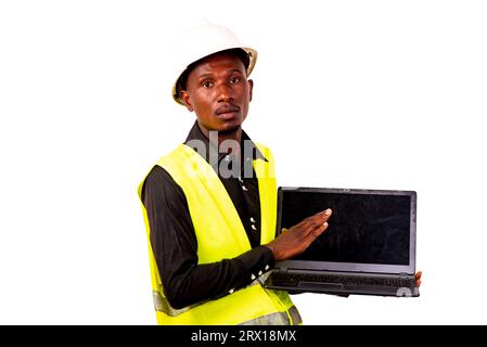 construction engineer with safety helmet standing on white background with laptop and looking at camera. Stock Photo
