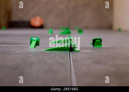 Plastic tile leveling system clips and wedges leveling install tools tile leveling system spacer. Stock Photo