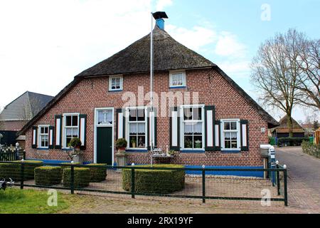 Staphorst, Netherlands. Facade of the typical farm house painted in traditional colors of the Dutch village. Stock Photo