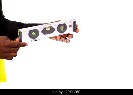 hand of an unknown person holding holding a gray level tool on a white background. Stock Photo