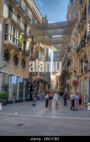 HDR image of people walking along the shopping street of Calle traperia in the city of Murcia Spain Stock Photo