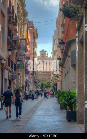 HDR image of people walking along the shopping street of Calle traperia in the city of Murcia Spain Stock Photo