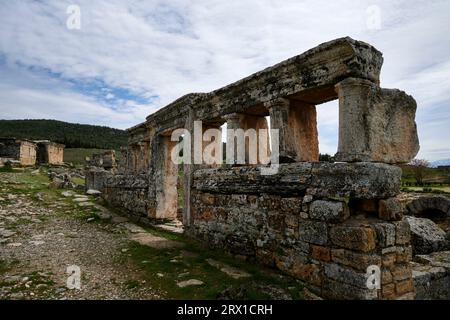 Ancient, aged building in ruins with stone walls and cloudy sky. Stock Photo