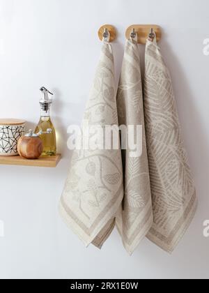several towels for the kitchen are hanging on a hanger. Stock Photo