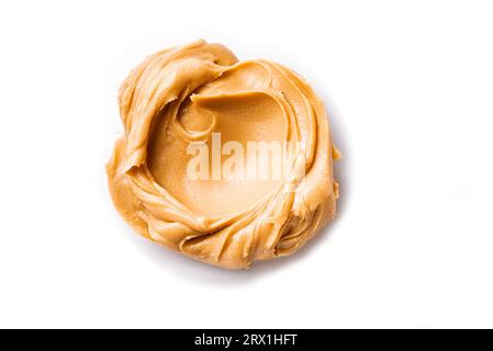Peanut Butter isolated on white background. Swirl of peanut spread close up. Stock Photo
