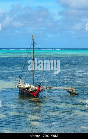 Traditionesses Dugout Canoe Dugout canoe lies in turquoise blue lagoon of Yap Island in Pacific Still Ocean, Yap Island, Yap State, Caroline Islands Stock Photo