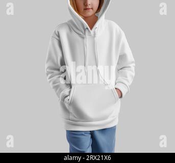 White hoodie template on hooded girl, fashionable clothes isolated on background. Kid's long sleeve mockup, apparel for design, print, front view. Pro Stock Photo