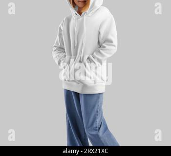 Template of white hoodie on girl with hood, drawstrings, pocket, stylish clothes, isolated on background, front view. Mockup of a textured kid's long Stock Photo