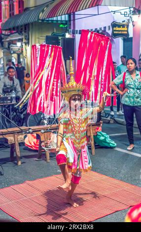 Phuket, Thailand - 23 February 2018: Menora thai traditional dancing on night city street. Tradition Nora dance drama in town. Dance is essentially ri Stock Photo