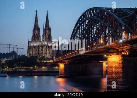 Cologne Cathedral, UNESCO World Heritage Site, and Hohenzollern Bridge at dusk, Cologne, North Rhine-Westphalia, Germany, Europe Stock Photo