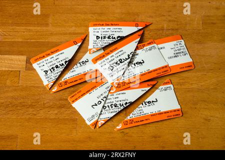 Train tickets cut in half ready to claim refund from Great Northern following train cancellation due to service disruption. Stock Photo