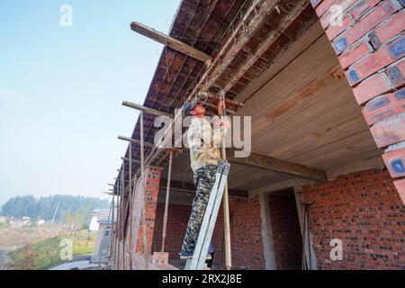 Luannan County, China - September 28, 2022: The construction workers are adjusting the construction template on a construction site, North China Stock Photo