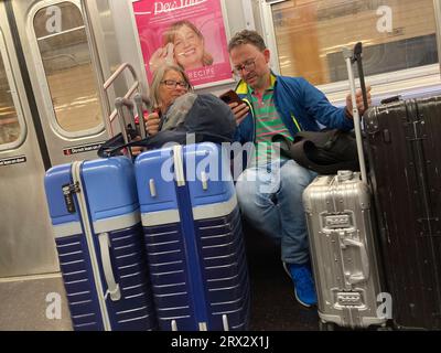 Subway riders with their luggage in New York on Sunday, September 17, 2023. (© Frances M. Roberts) Stock Photo