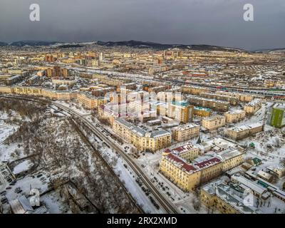 The aerial panorama view of the streets, buildings, and residential areas of the Ulan-Ude, Republic of Buryatiya, Russia, during the cold winter day. Stock Photo