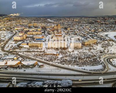 The aerial panorama view of the streets, buildings, and residential areas of the Ulan-Ude, Republic of Buryatiya, Russia, during the cold winter day. Stock Photo